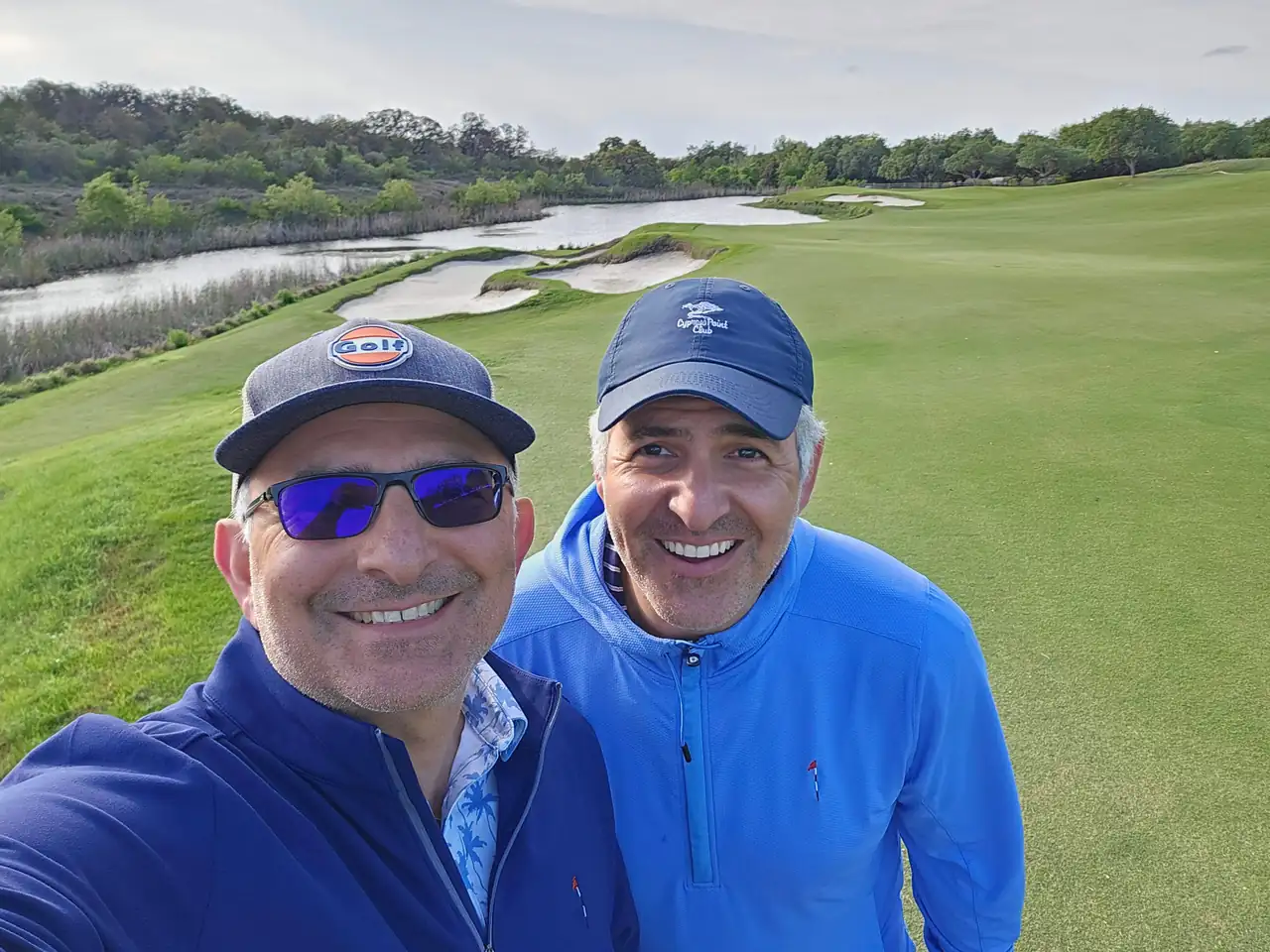 The Perry Bros on a Briggs Ranch fairway with the green and bunkers behind them