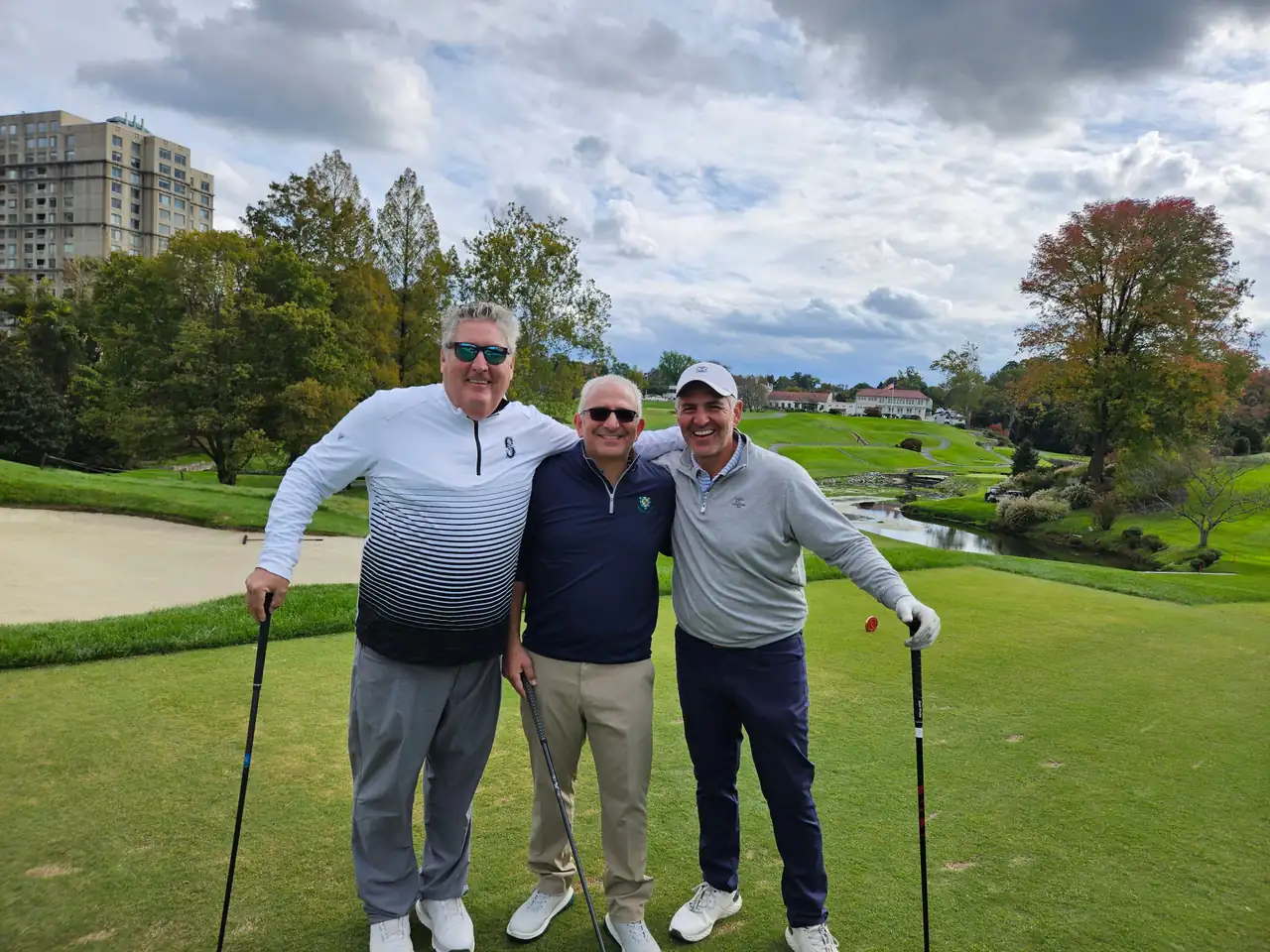Three golfers on a Columbia Country Club tee