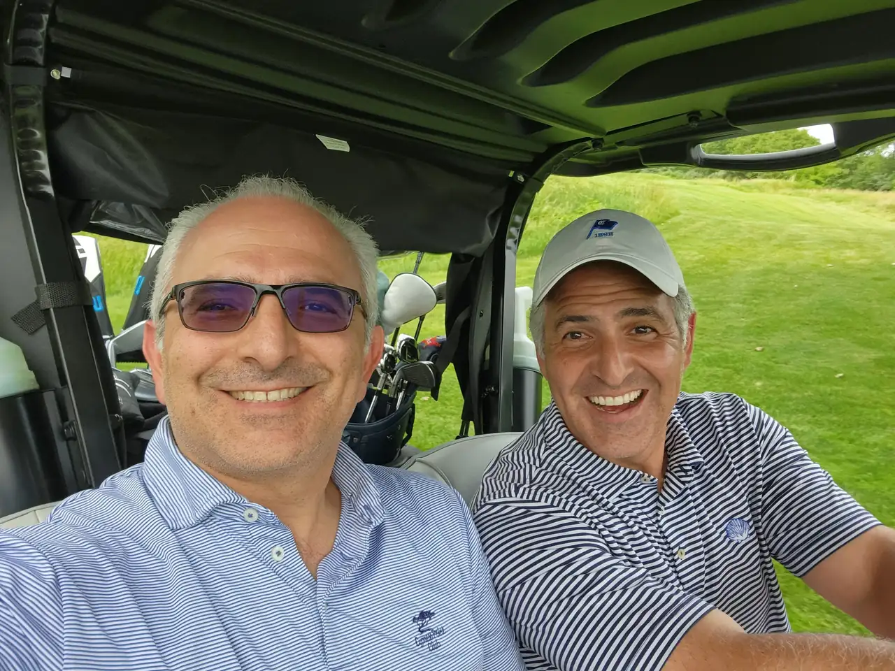 The Perry Bros grinning in a golf cart at Victoria National Golf Club